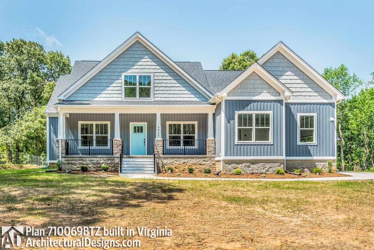 House plan exterior: Ranch style with a covered front porch, gabled dormers, and stacked stone foundation.