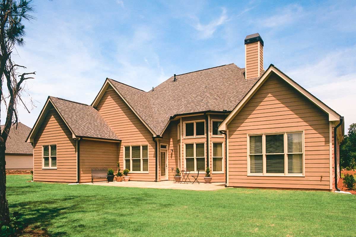House plan exterior: Ranch style, two stories, gables, large windows, and prominent chimney.