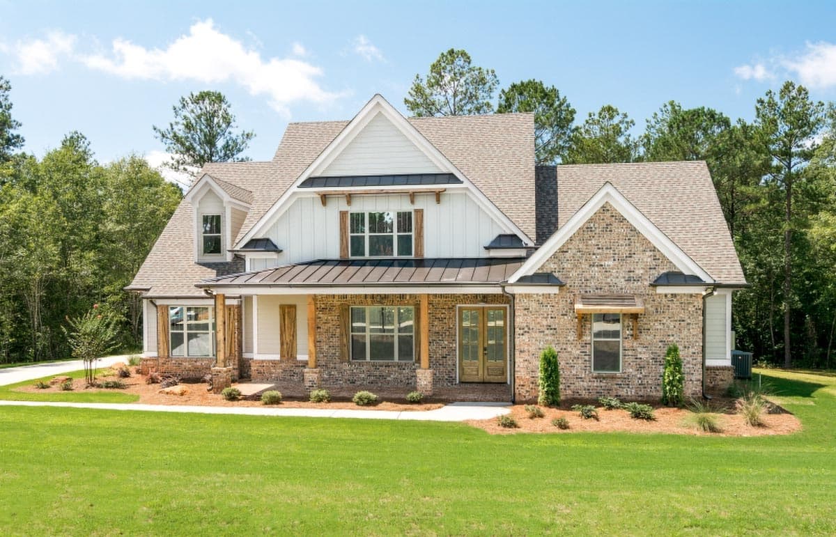 House plan exterior: Modern Farmhouse style, two stories, prominent gables, covered porch with wood columns, brick and board-and-batten siding.