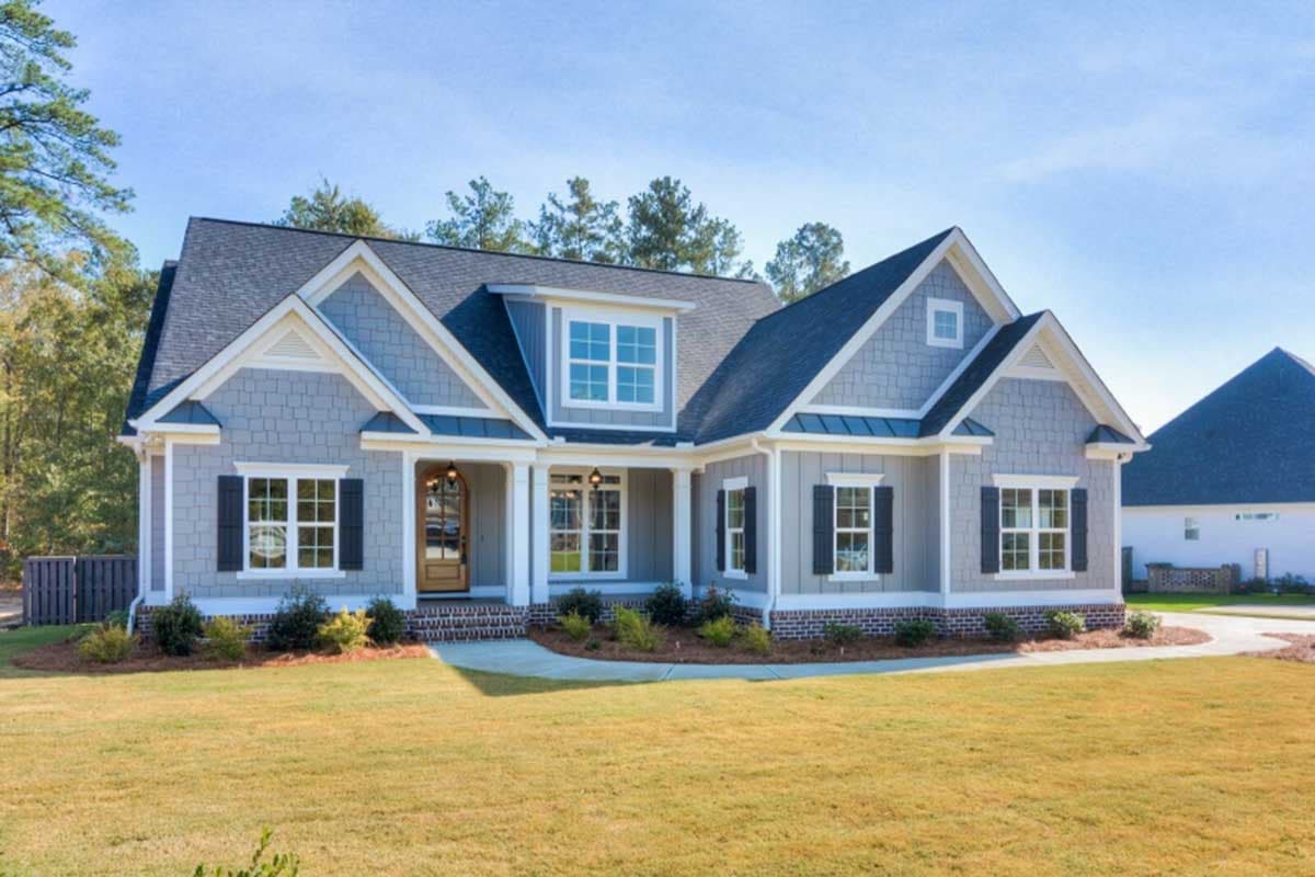 House plan exterior with Craftsman style, one story, and gabled roof. Features include dormer, front porch, and black shutters on windows.
