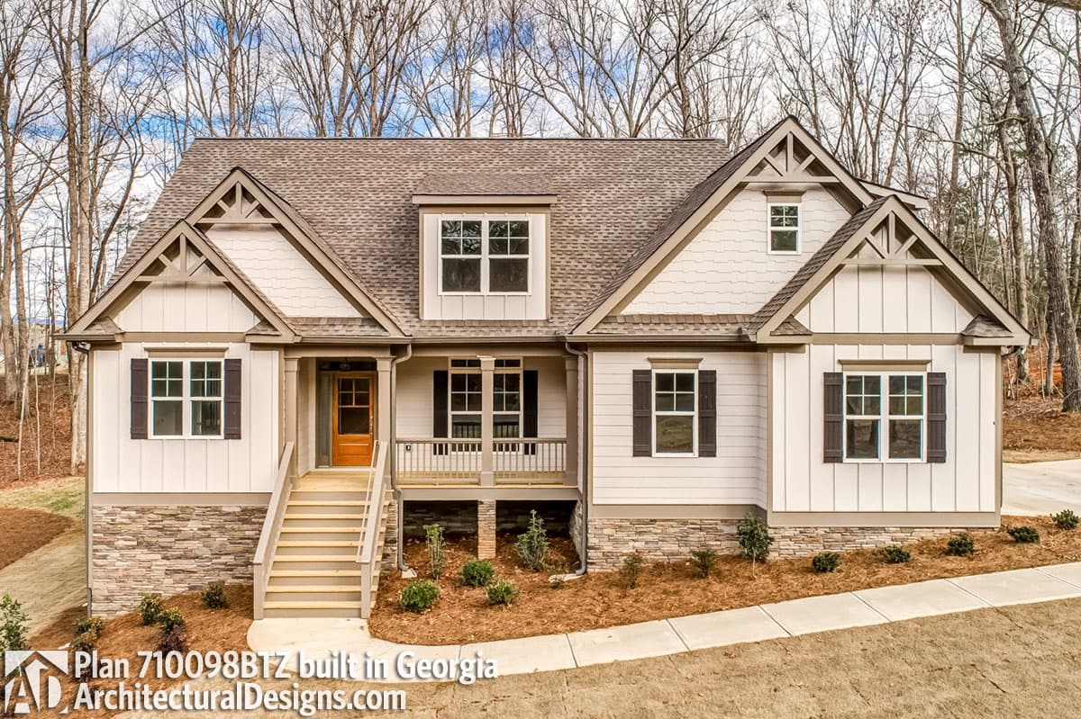 House plan exterior: Ranch style, two stories, front porch, gabled dormers, and stone skirting.