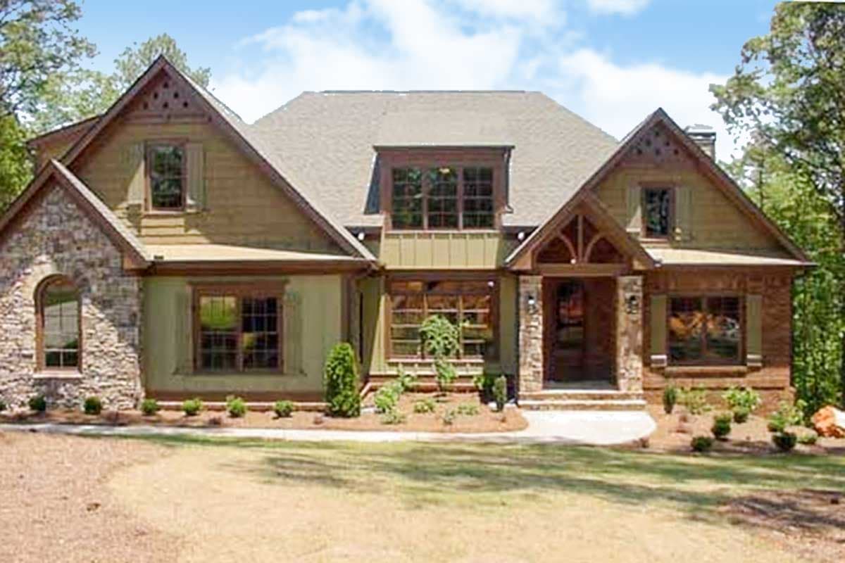 Craftsman style house plan exterior with stone and siding, gables, dormer window, and covered entry.