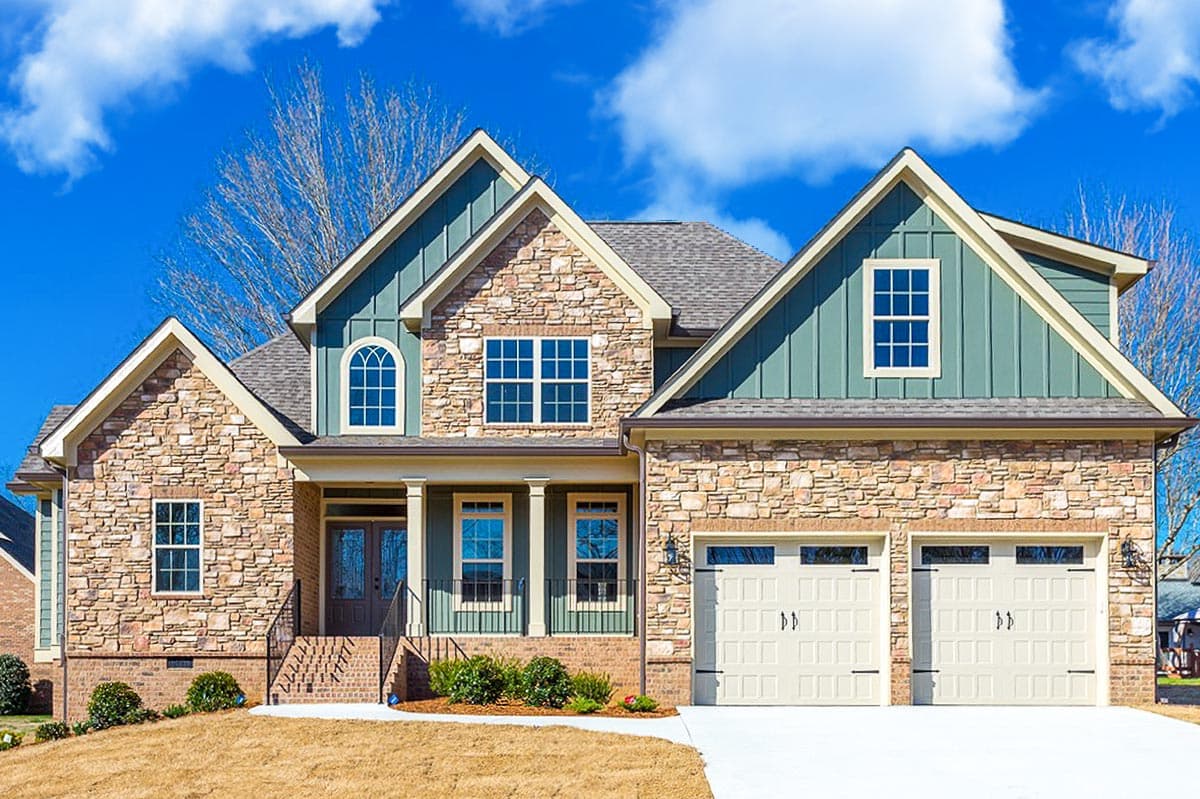 House plan exterior featuring Craftsman style, two stories, gabled rooflines, a front porch, and a two-car garage.