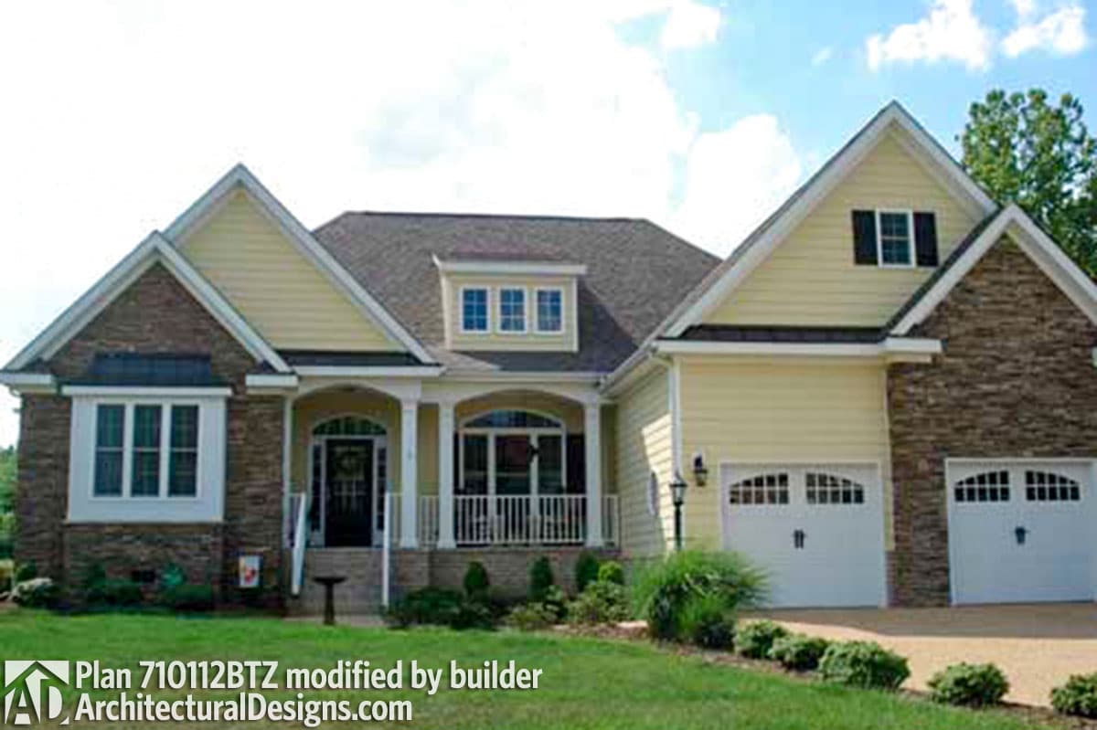 House plan exterior: Ranch style, one story, stone accents, covered front porch, and two-car garage.