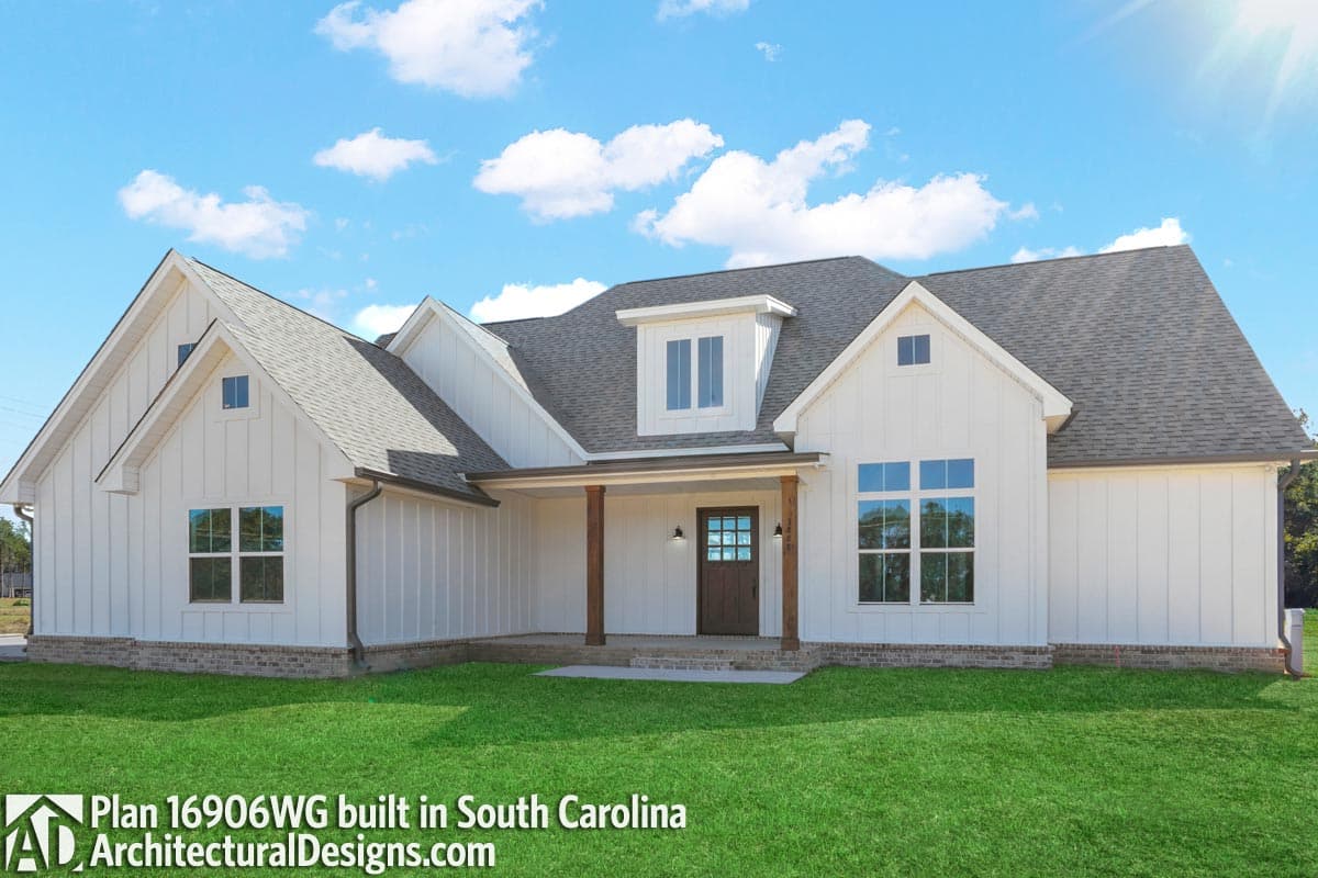House plan exterior: Modern Farmhouse style, single story, white board and batten siding, covered porch with wood columns, gables, and dormer.