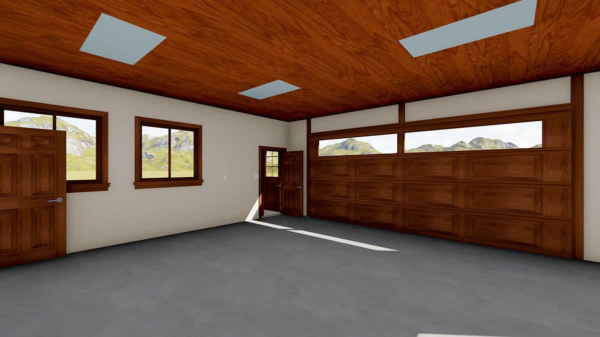 Interior view of a garage with wood paneled garage door, two windows, a side door, and skylights in the wood ceiling.