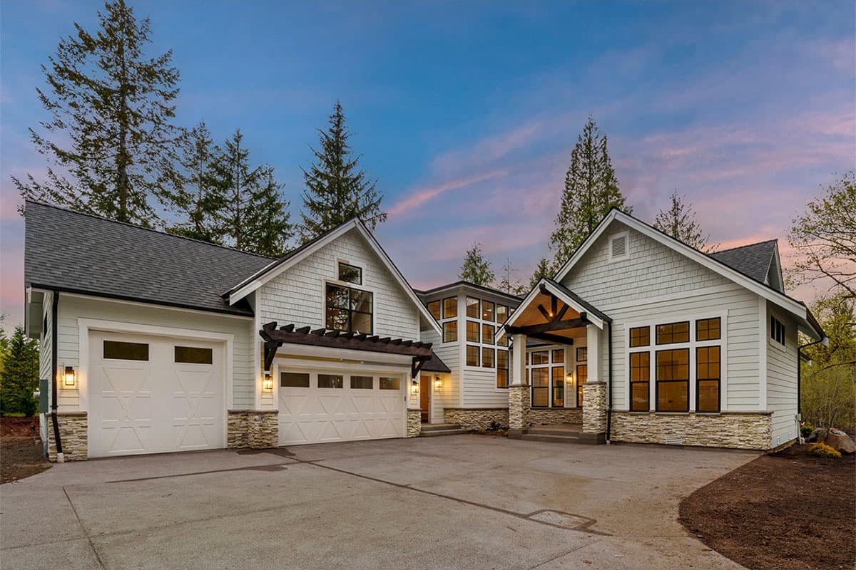 House plan exterior: Modern Farmhouse style with two garage doors, stone accents, gables, and a covered entry with exposed beams.
