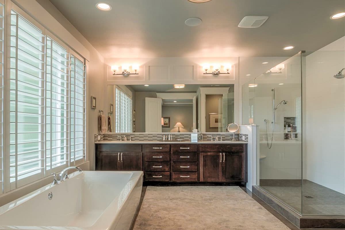 Master bathroom with soaking tub, double vanity, and glass-enclosed shower.