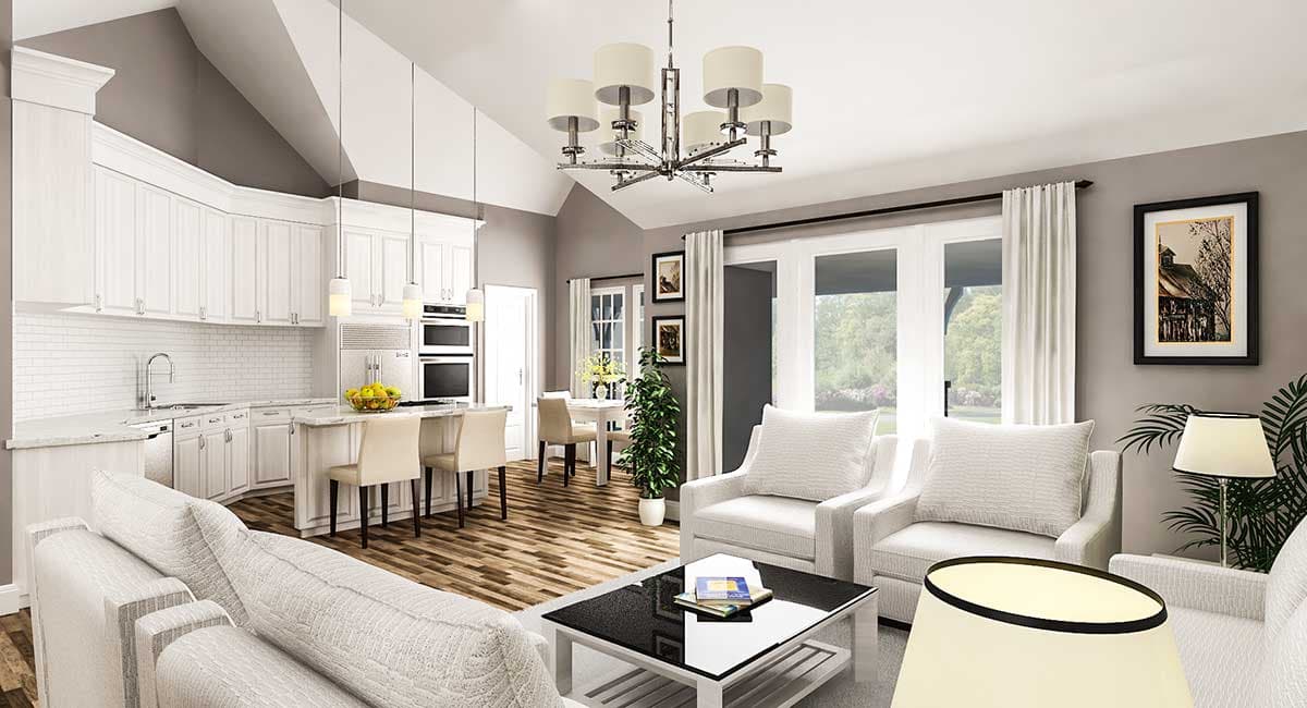 Open concept living and kitchen area with vaulted ceiling, white cabinets, subway tile backsplash, island, and dining nook.