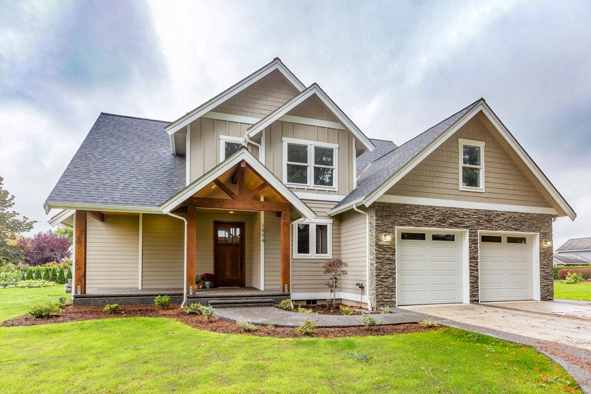 Exterior house plan: Two-story home with a covered wood-beam entry porch, stone accents, and a triple garage.