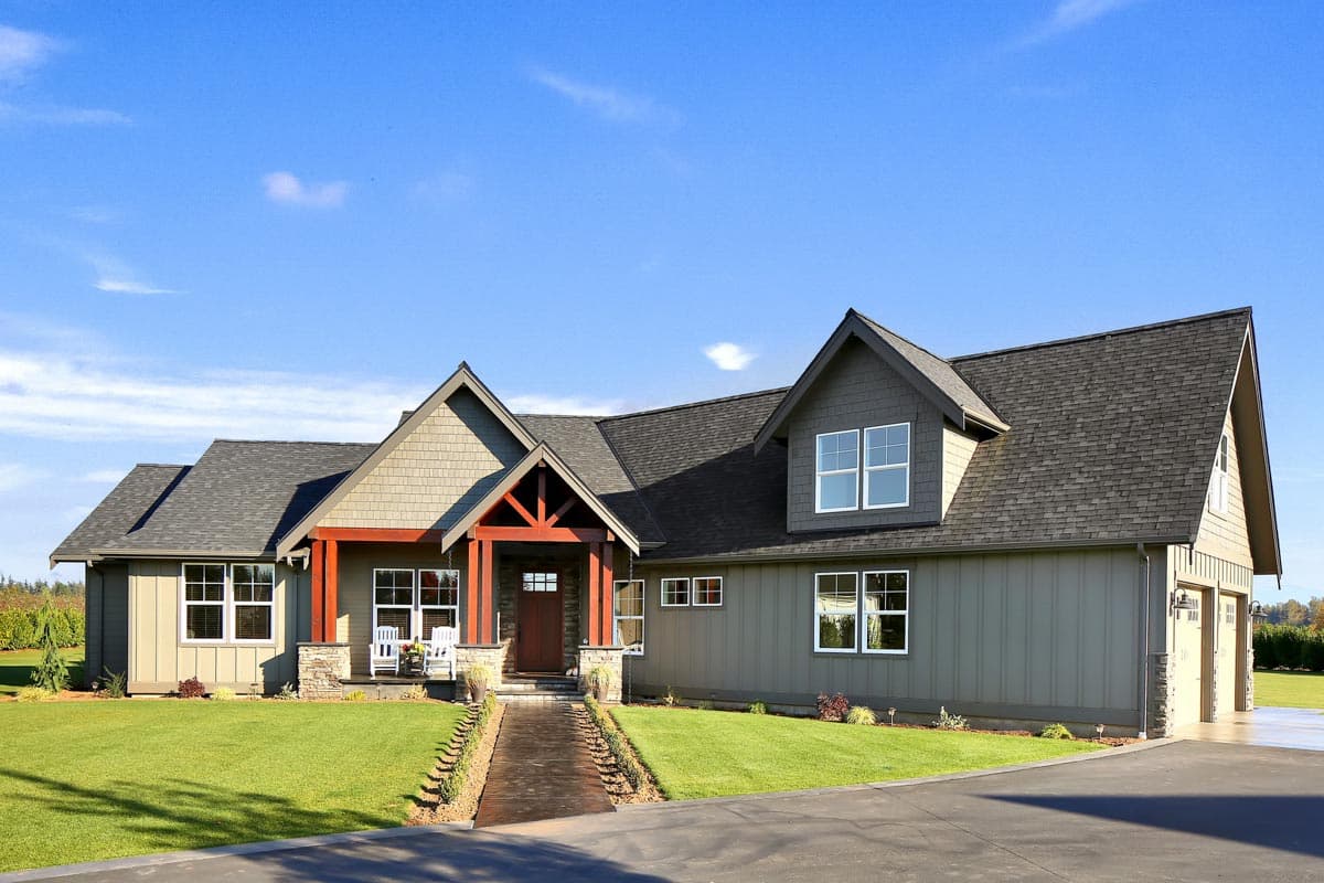 House plan exterior featuring Craftsman-style elements. One-story home with gabled roof, dormers, and a covered porch with exposed beams.