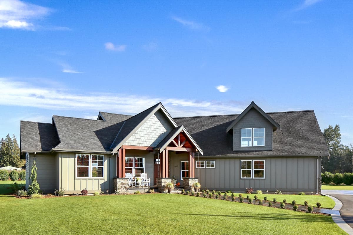 House plan exterior: Modern Farmhouse style, one-and-a-half stories, with gabled dormers, covered porch, and varied siding.