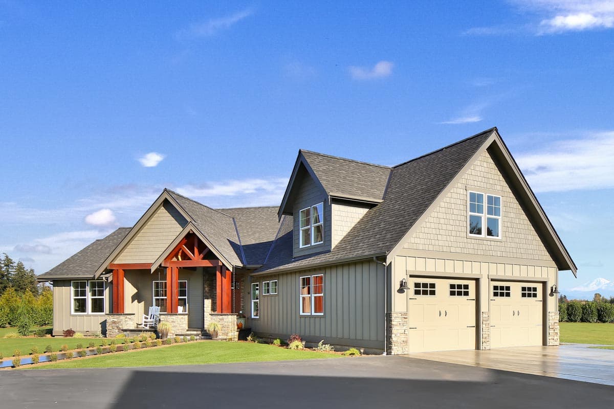 House plan exterior: Modern Farmhouse style, two stories, prominent gables, covered porch with timber accents, and a three-car garage.