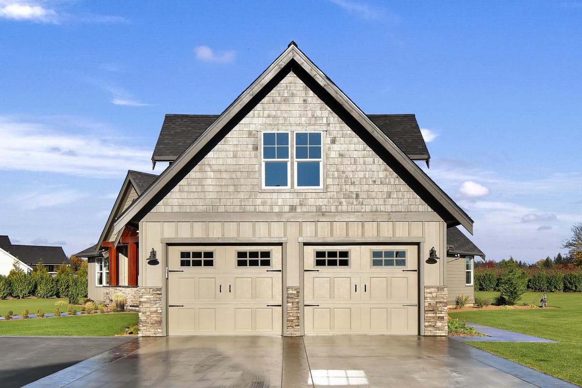 House plan exterior featuring a gable roof, stone accents, board and batten siding, and a double garage.