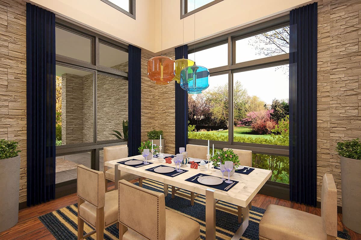 Dining room with stone accent wall, large windows, and a table set for six.