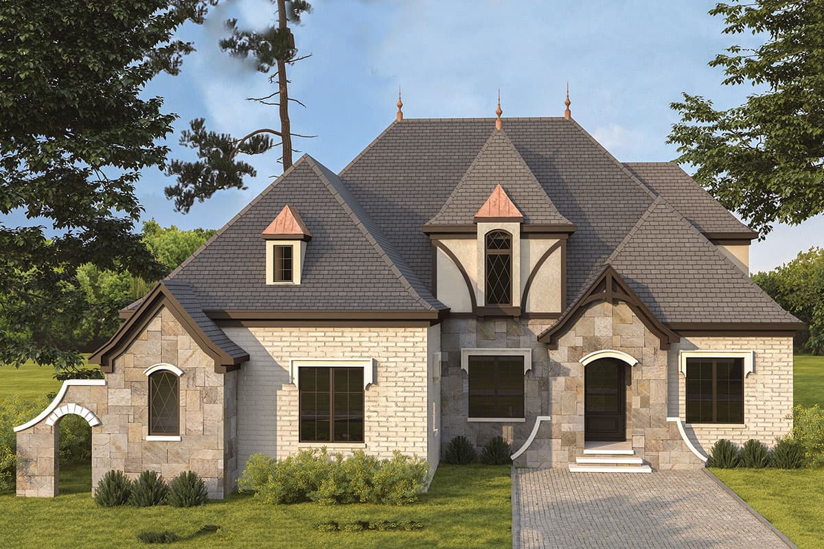 House plan exterior. Two-story French style home with a steep roof, multiple dormers, stone and brick facade, and an arched entry.