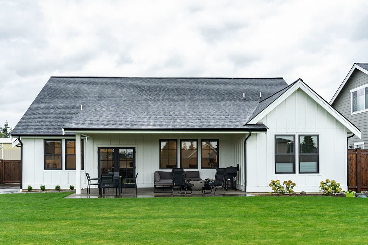 Modern Farmhouse house plan exterior with board and batten siding, gables, and covered patio.