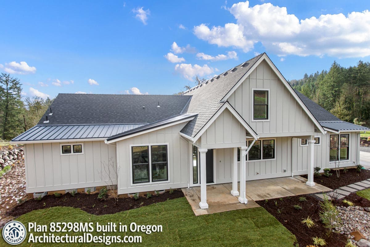 House plan exterior with gables, metal roof, and a covered porch entrance. Modern Farmhouse style.