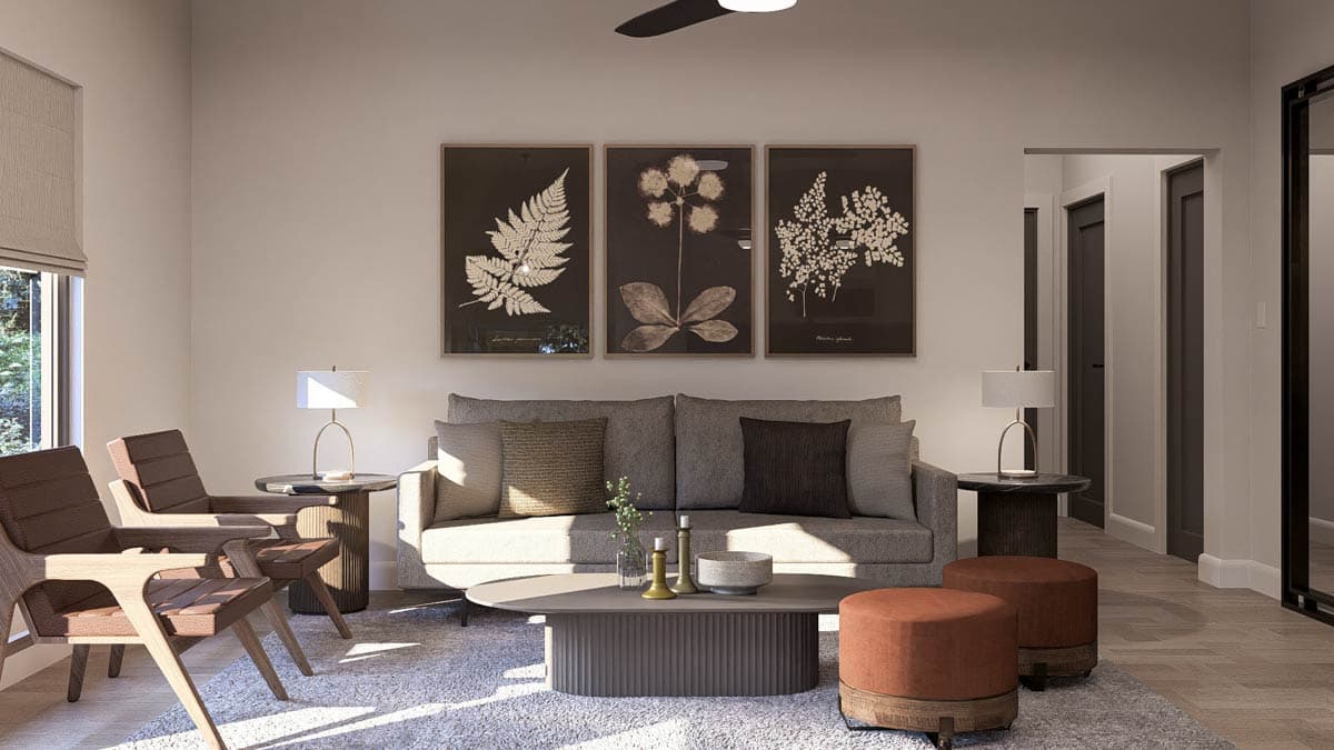 Living room with sofa, armchairs, coffee table, and three botanical prints on wall.
