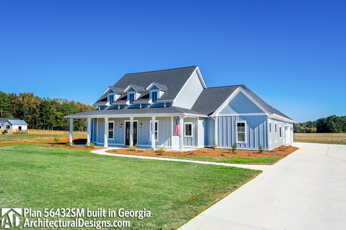 Modern Farmhouse house plan exterior with a wraparound porch, multiple gables, and a three-car garage.