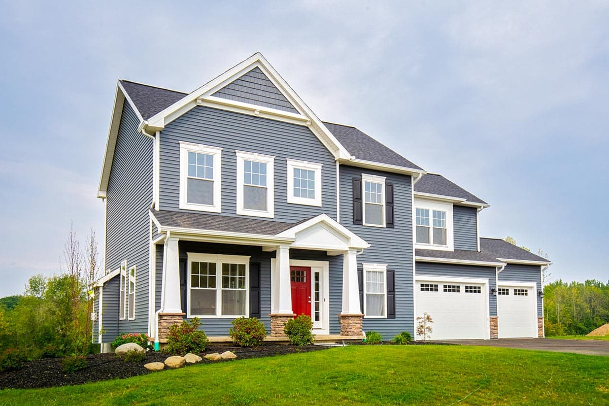 Two-story house plan exterior with siding, covered entry porch, gable, and a three-car garage.