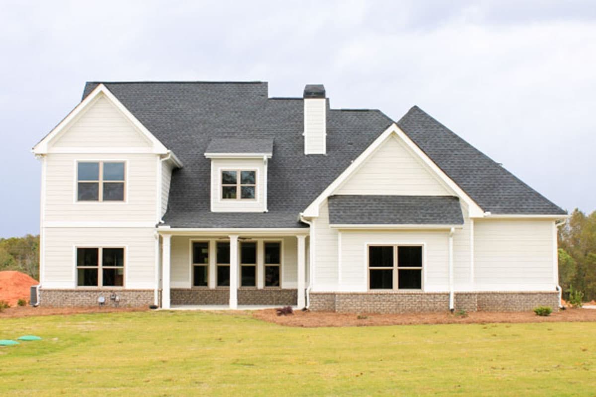 House plan exterior: Two-story Modern Farmhouse with gables, dormer, covered porch, and white siding.