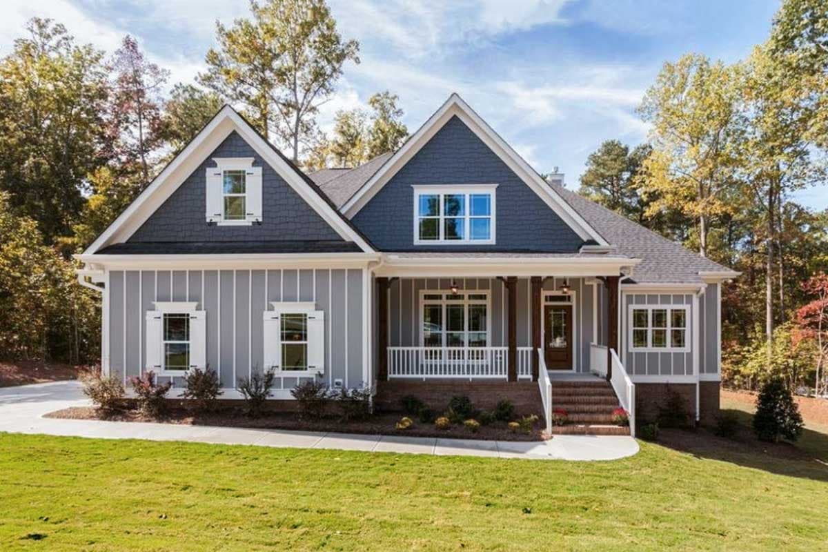 House plan exterior. Craftsman style, single-story house with a front porch, gables, and a prominent roofline.