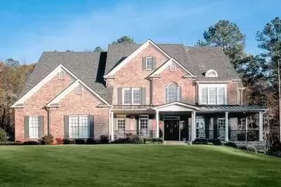 Traditional House Plan with Wrapping Porch and 2-Story Family Room