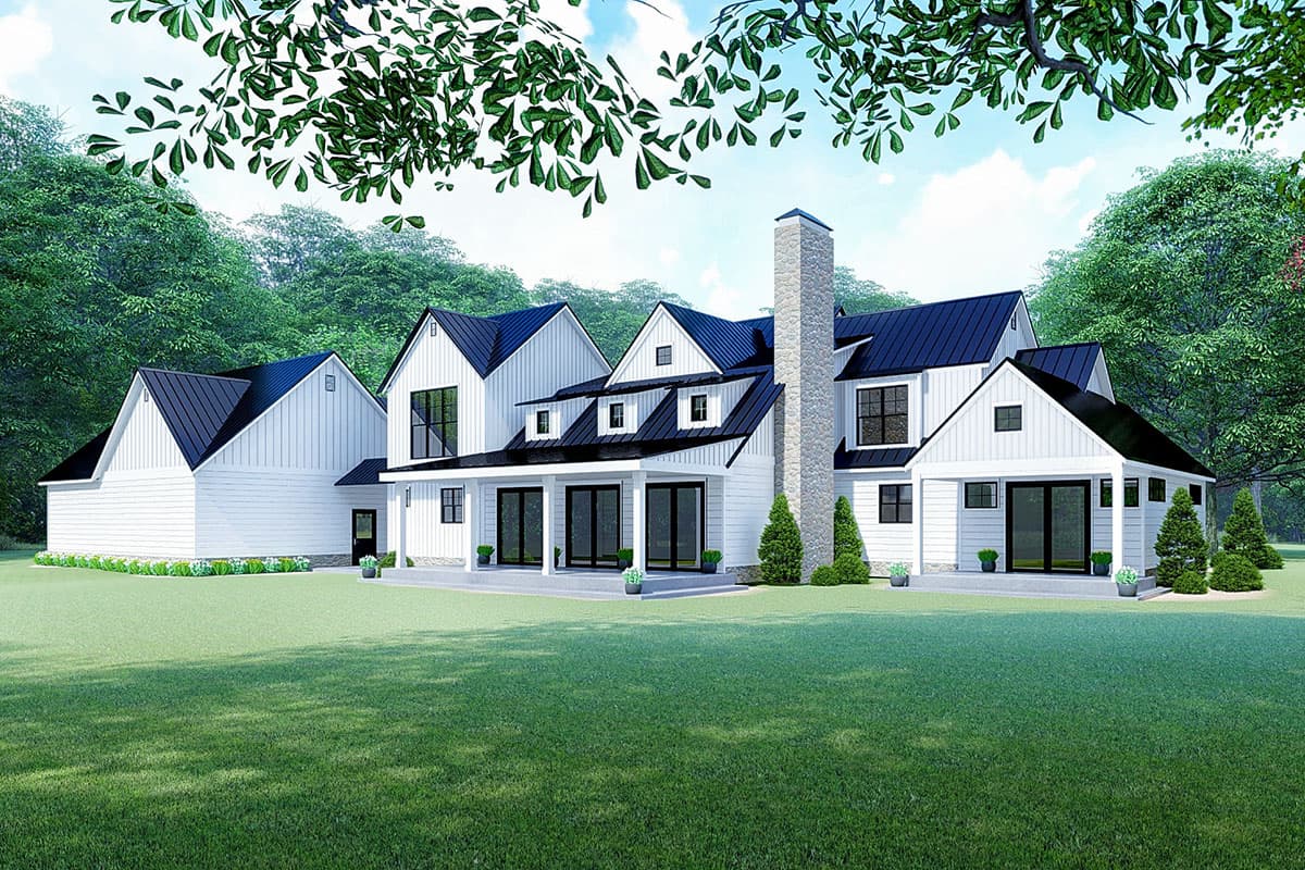 Modern Farmhouse house plan exterior with white siding, black metal roofs, gables, dormers, and a stone chimney.