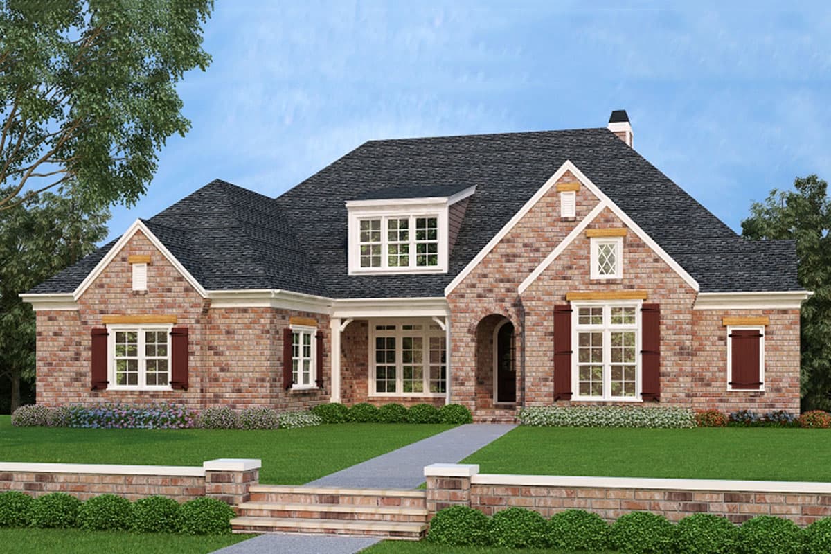 House plan exterior. One-story brick home with gabled roof, dormers, and front porch. Includes shuttered windows, and arched entry.