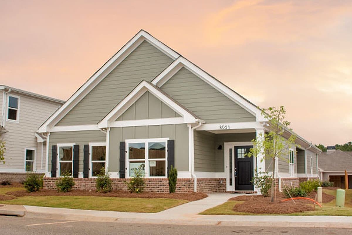House plan exterior featuring a Craftsman style with a single story, gable roof, and brick facade on the lower portion of the exterior.