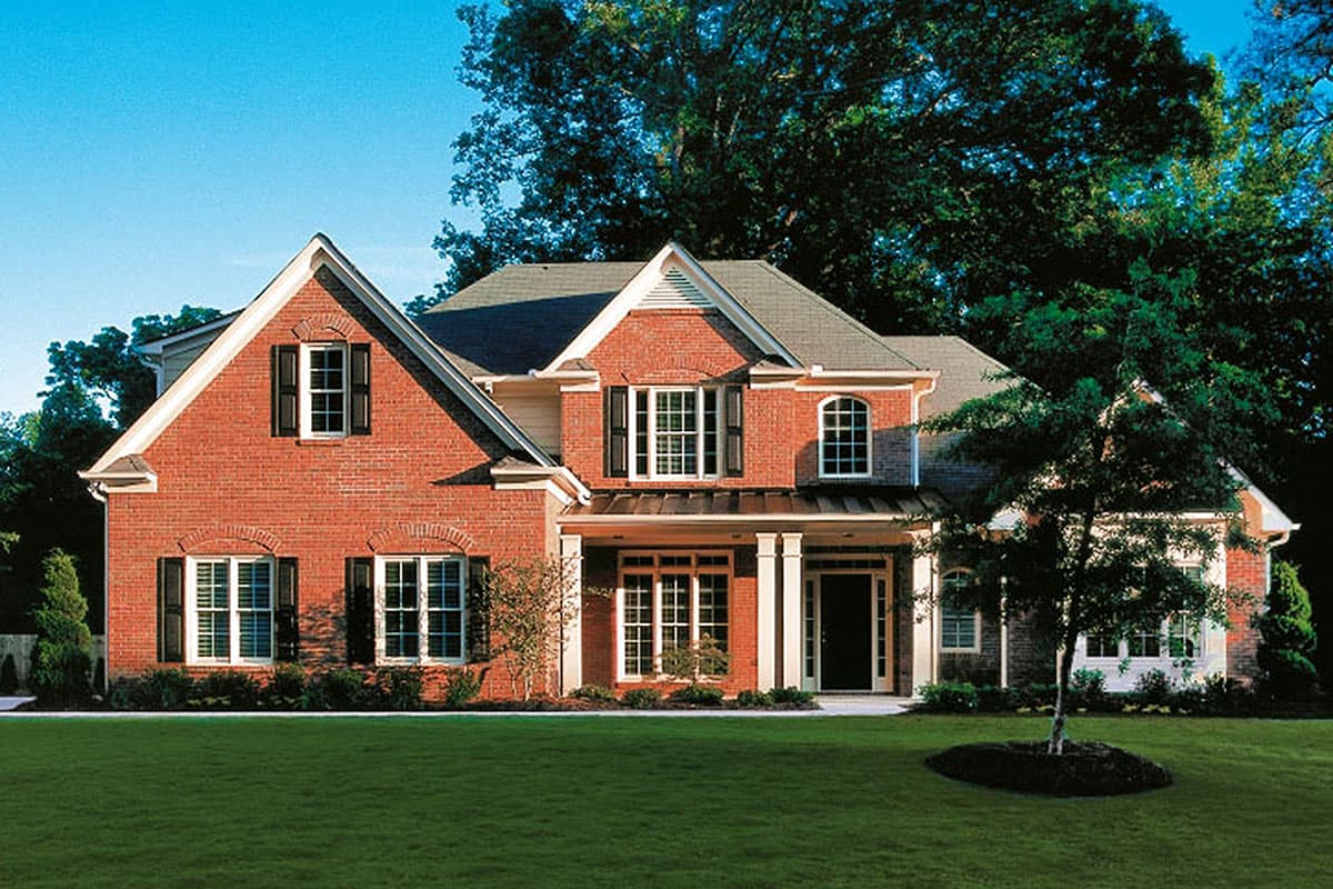 House plan exterior of a two-story brick home with gables, a covered porch with columns, and varied window styles.