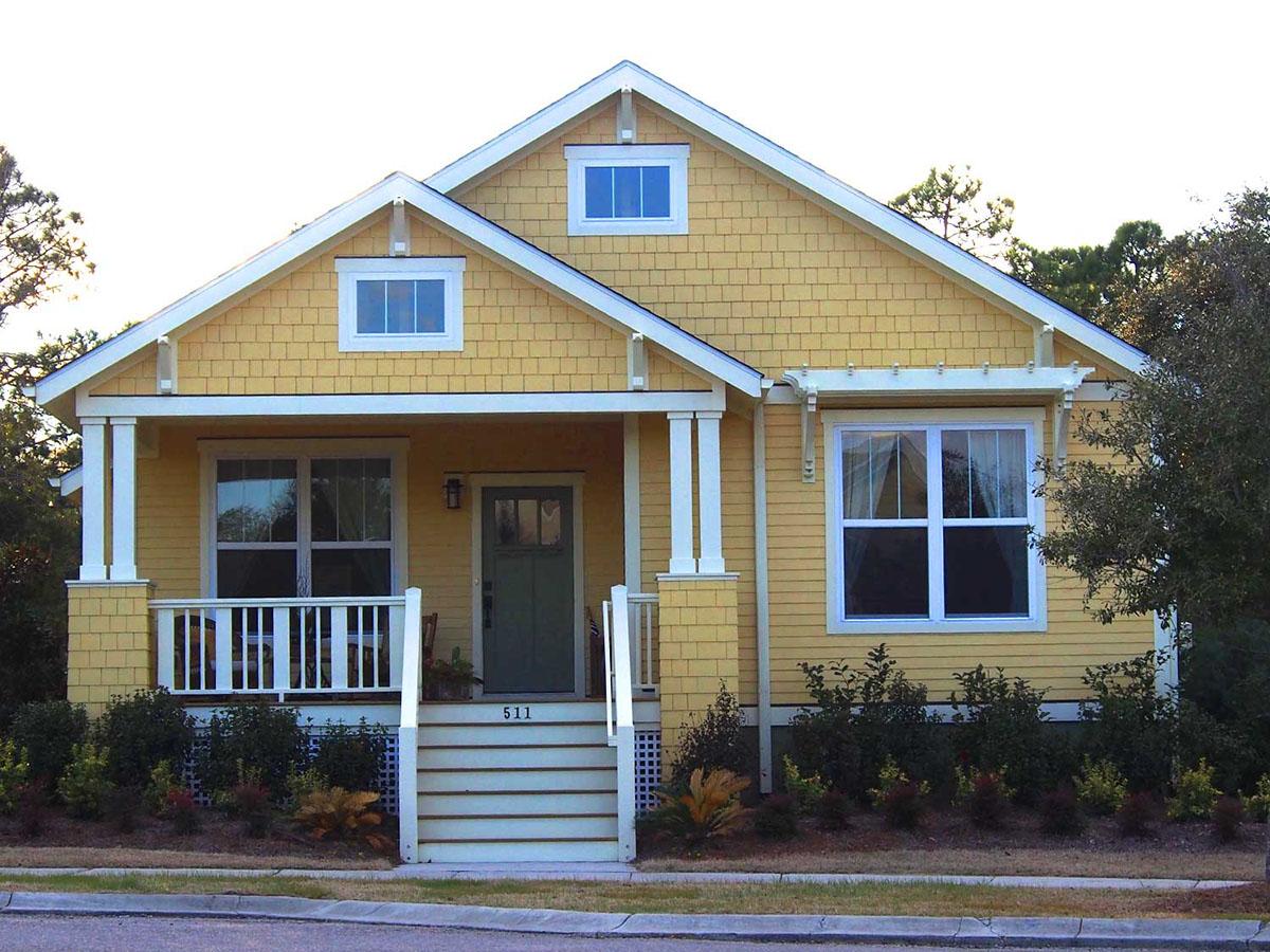 House plan exterior of a one-story Craftsman style home with a covered porch, gables, and shingle siding.