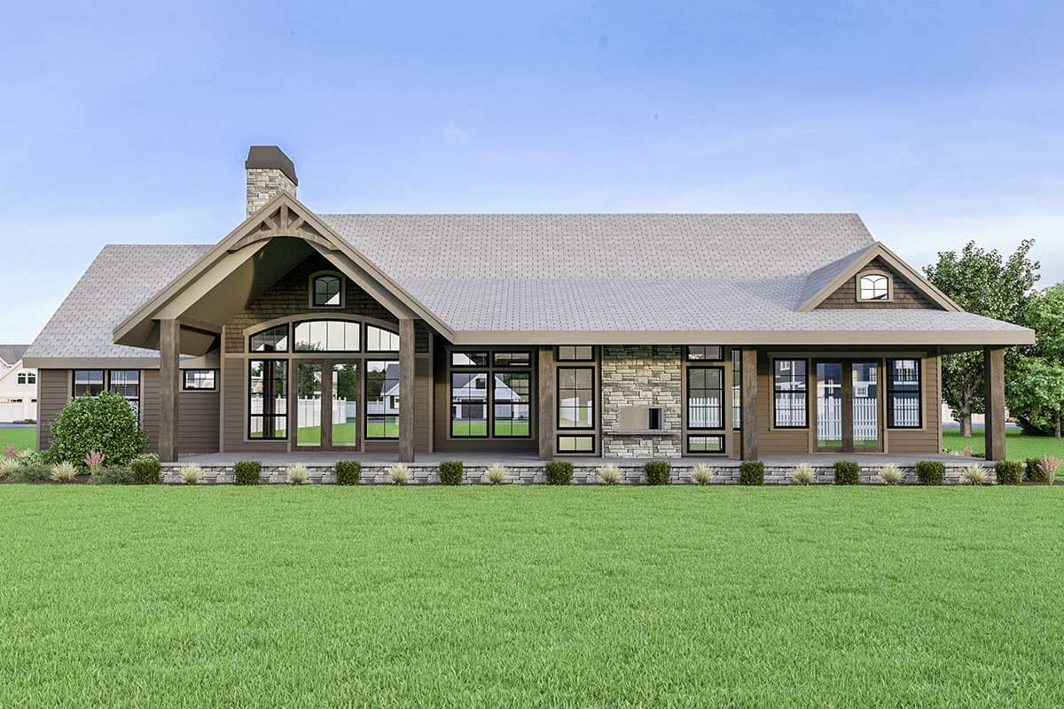 House plan exterior: Ranch style, stone chimney, large gable over entry, wrap-around porch, and extensive windows.