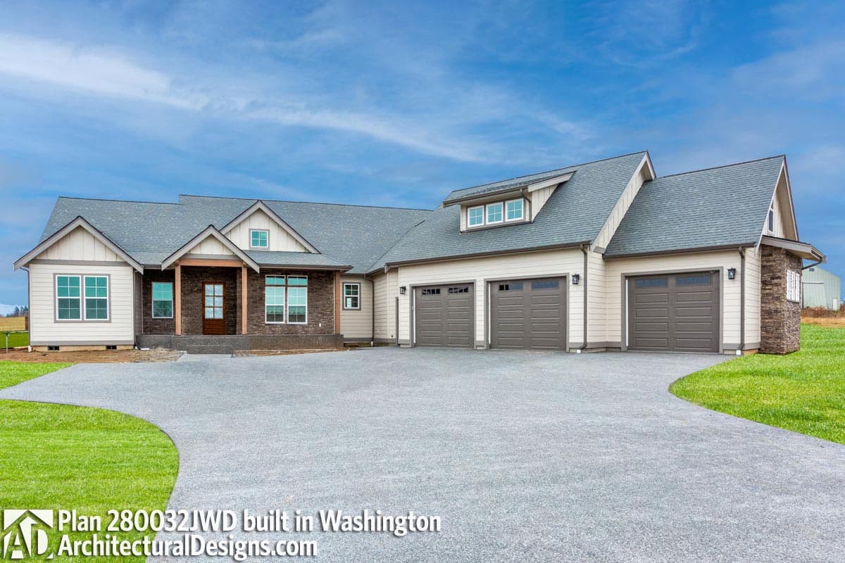 House plan exterior, two stories, gabled dormer, wood-columned entry, and attached five-car garage.