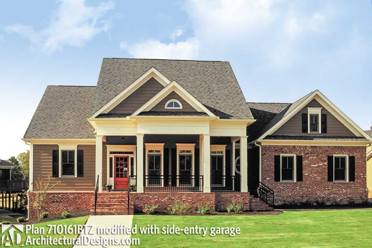 House plan exterior: One-story, red brick and siding, prominent covered porch with columns, dormer, side-entry garage.
