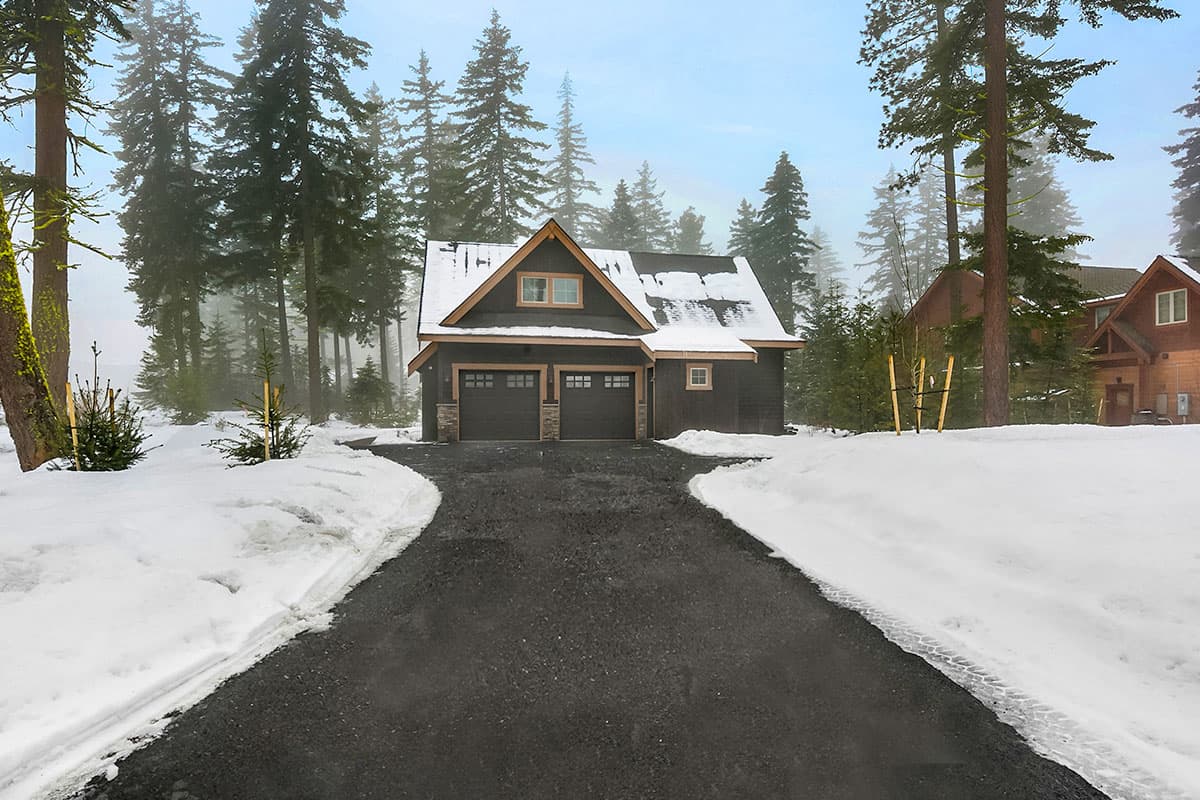 House plan exterior: Modern Farmhouse style, two-story with a front-facing two-car garage, gables, and dormers.