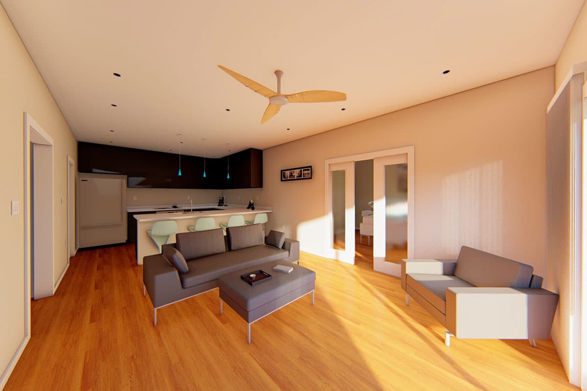 Open-concept living area with a kitchen island, seating, and large sliding glass doors leading to another room.