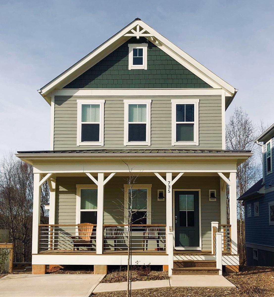 House plan exterior: Two-story modern farmhouse with a front porch, gables, and varied siding.
