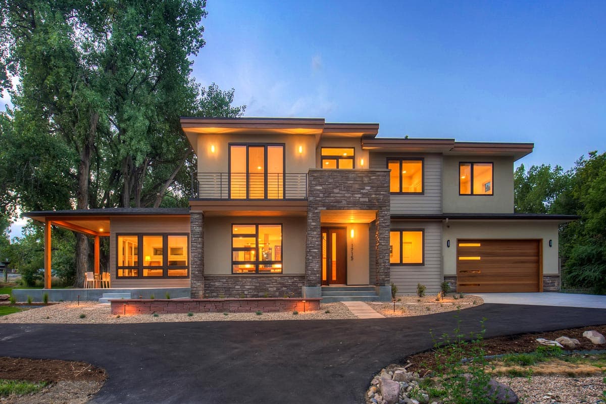 Modern two-story house plan exterior with flat rooflines, stone accents, expansive windows, balcony, and covered porch.