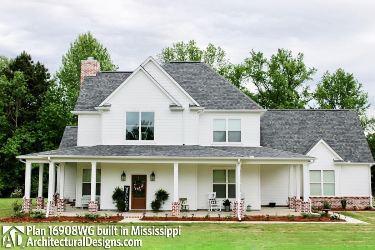 House plan exterior: two-story Modern Farmhouse with wrap-around porch, brick accents, gables, and dormers.