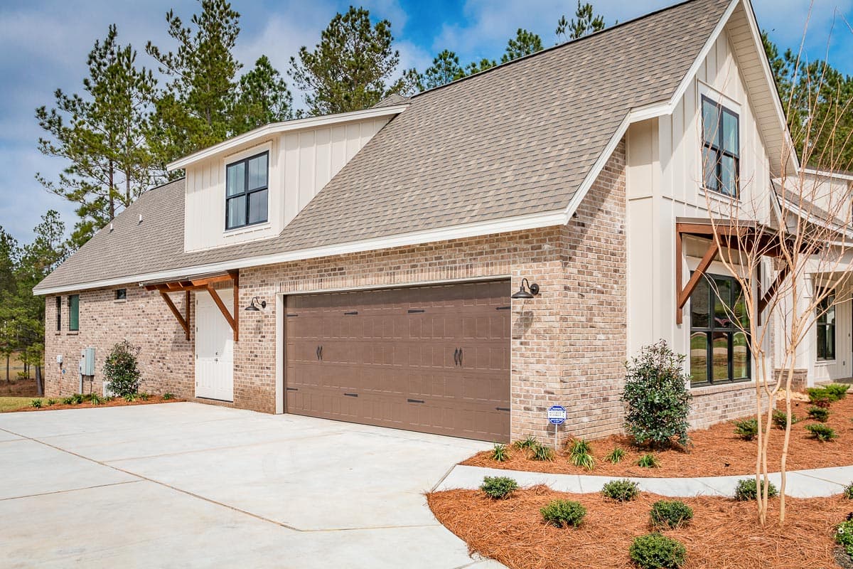 Modern Farmhouse house plan exterior with brick facade, gable dormer, and a two-car garage.