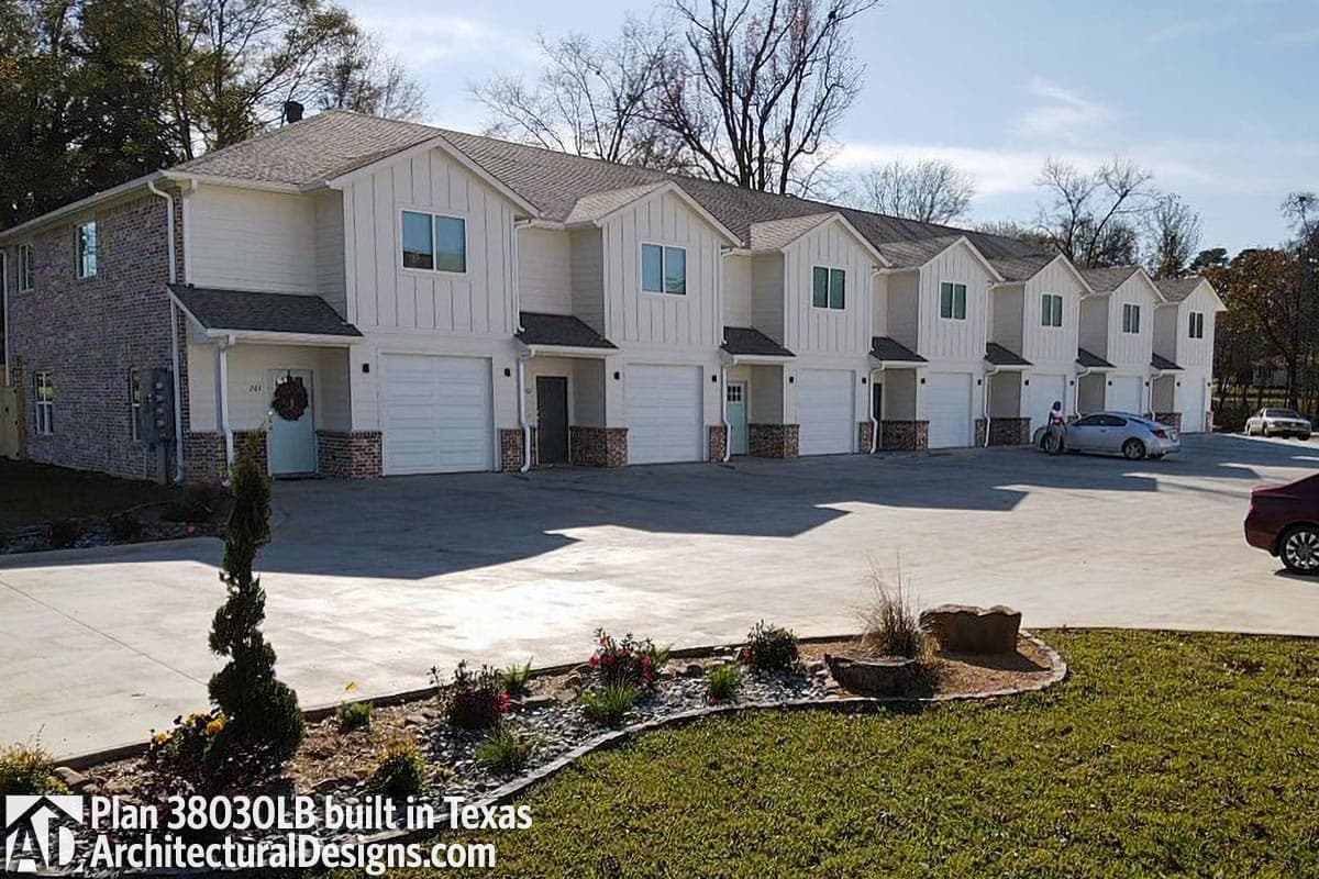 Modern Farmhouse townhouse exterior with two stories, gables, and attached garages.