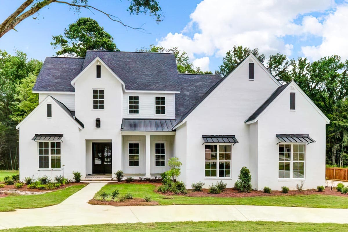 House plan exterior. Two-story Modern Farmhouse with gabled roof, black awnings over windows, and a covered porch with columns.
