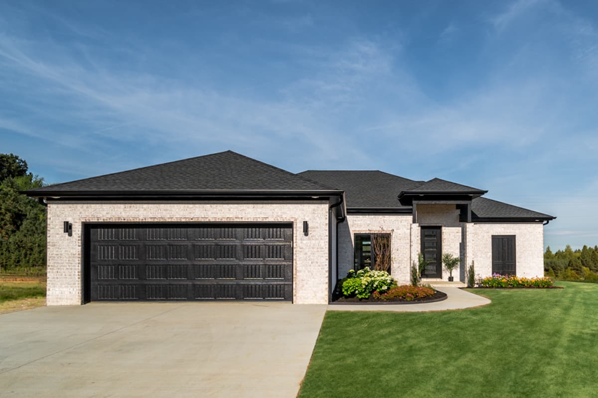 House plan exterior. Single-story modern home with light brick, black garage door, dark windows, and a covered entry.