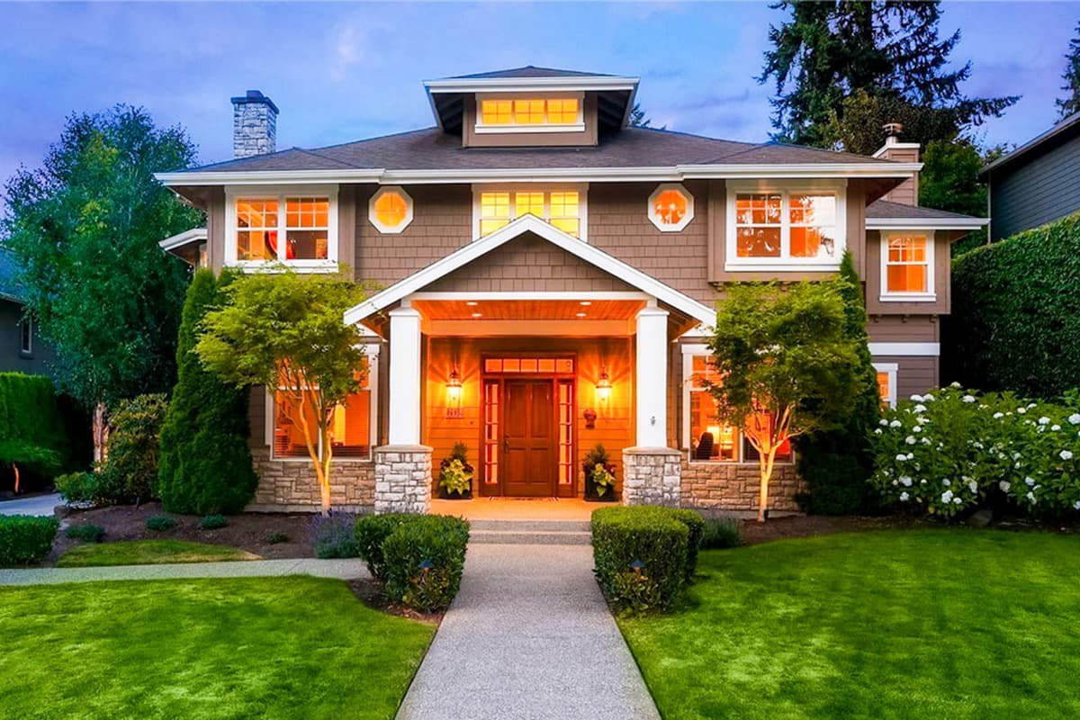 House plan exterior featuring a two-story Craftsman home with gabled roof, prominent front porch, and dormer windows.