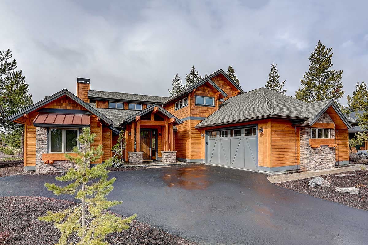 House plan exterior. Two-story, Craftsman-style home. Features include multiple gables, a front entry porch, and a side-entry garage.