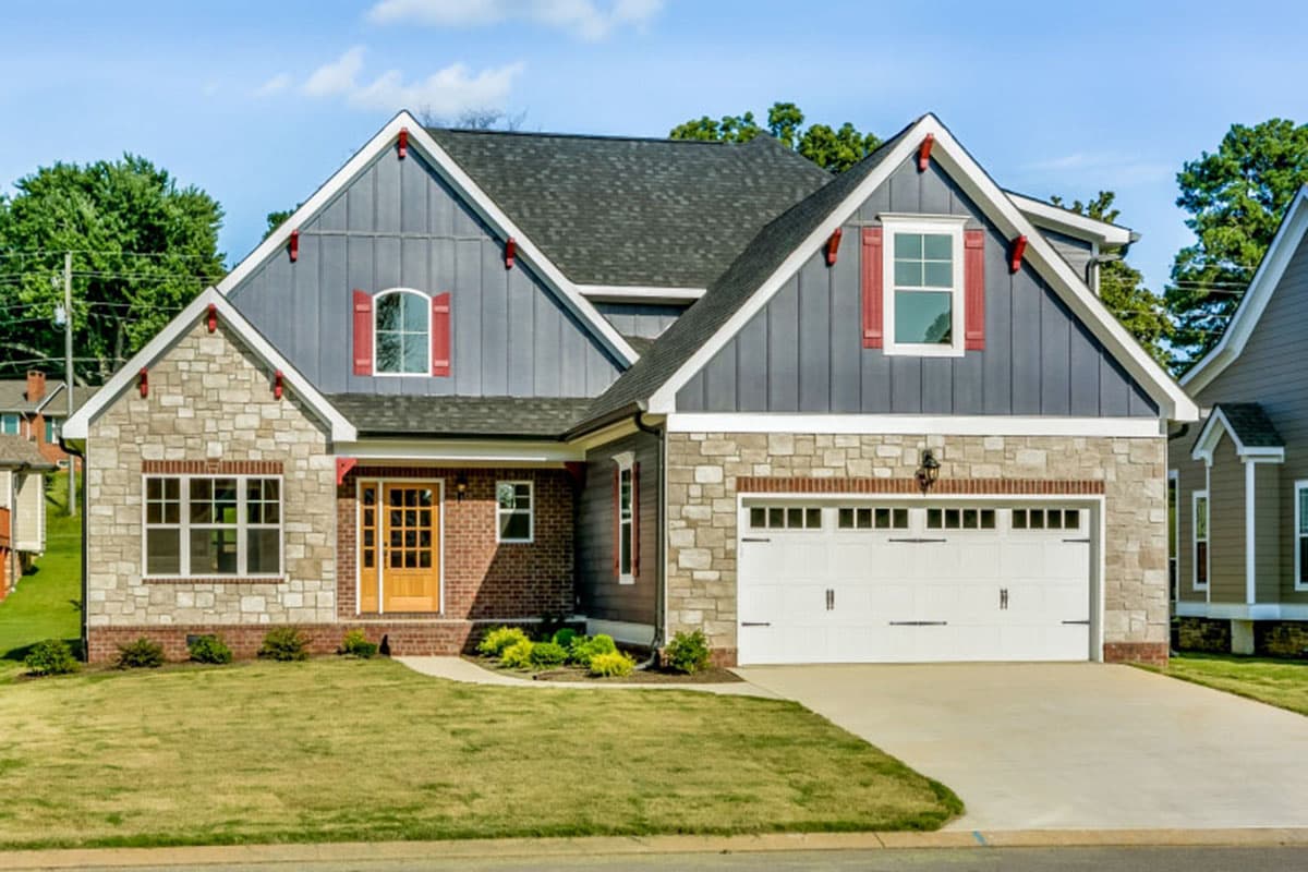 Modern Farmhouse house plan exterior with stone and board-and-batten siding, front-facing garage, and gabled dormers.