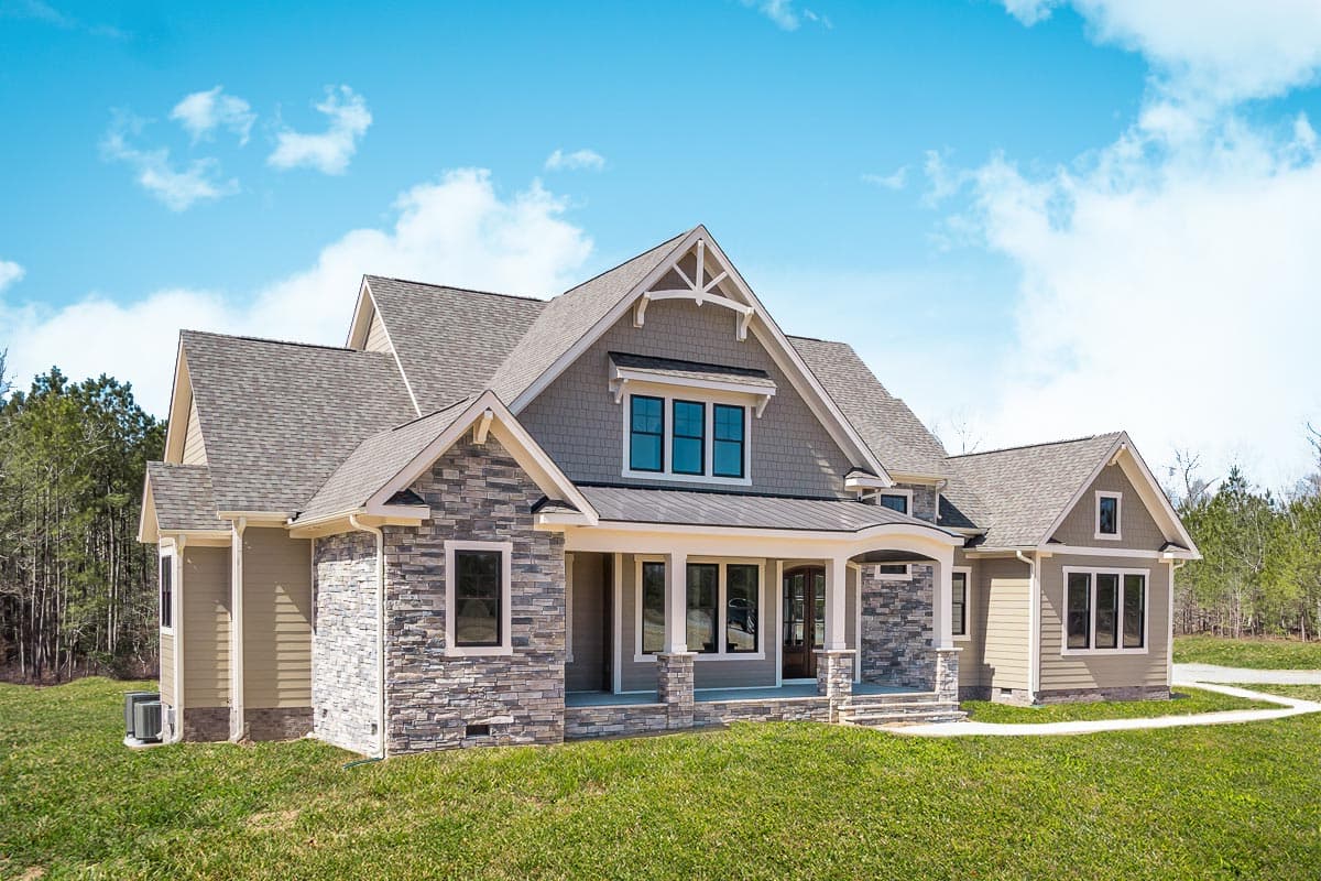 Craftsman style house plan exterior with stone accents, large front porch with columns, multiple gables, and dormer.