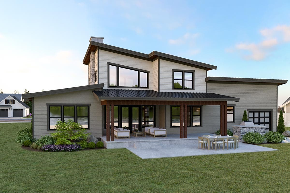 Modern house plan exterior with asymmetric rooflines, stone chimney, covered patio, and attached garage.